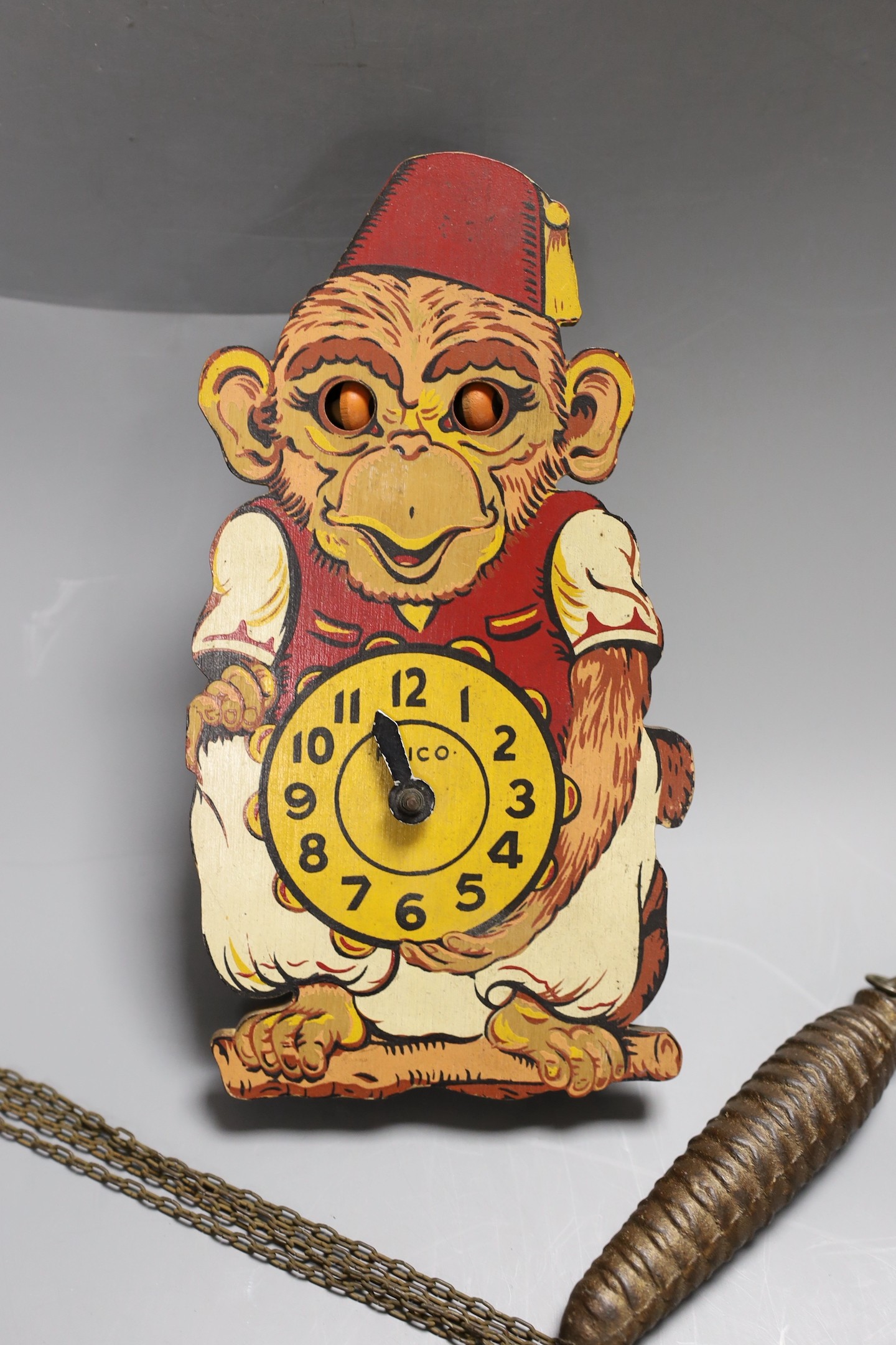 A Paico Wood and tin plate novelty monkey wall timepiece, 21cm